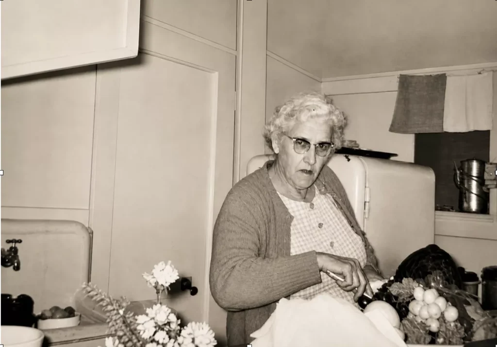 Elderly woman preparing vegetables in a vintage kitchen